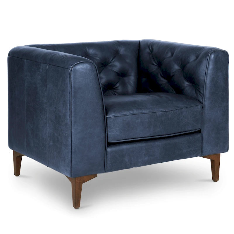 Fauteuil de salon capitonné en cuir italien avec pieds en bois massif et coussin en plumes