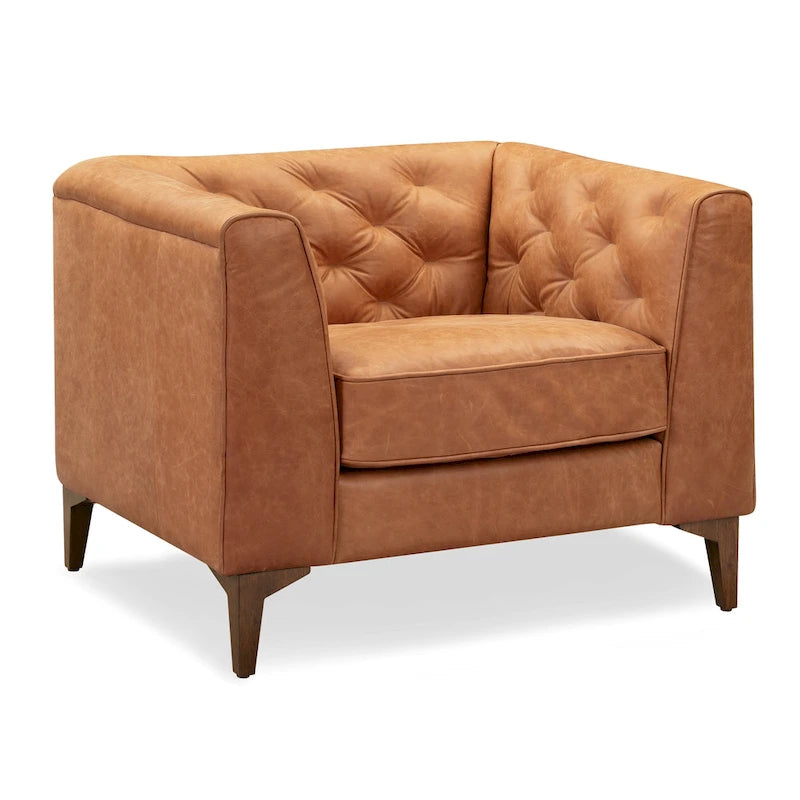 Fauteuil de salon capitonné en cuir italien avec pieds en bois massif et coussin en plumes