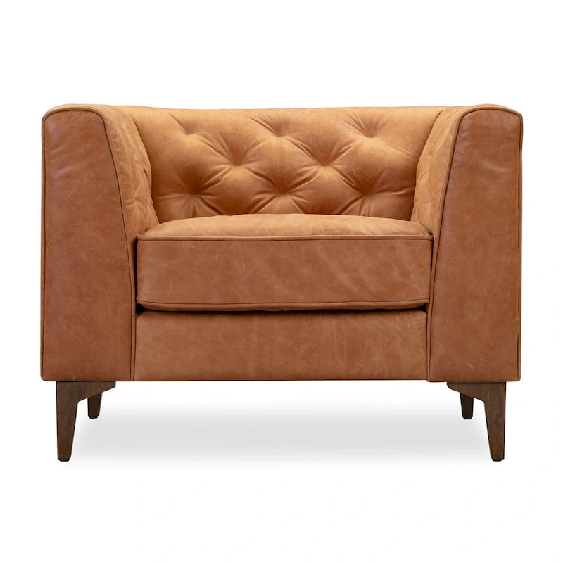 Fauteuil de salon capitonné en cuir italien avec pieds en bois massif et coussin en plumes