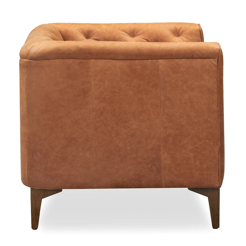 Fauteuil de salon capitonné en cuir italien avec pieds en bois massif et coussin en plumes