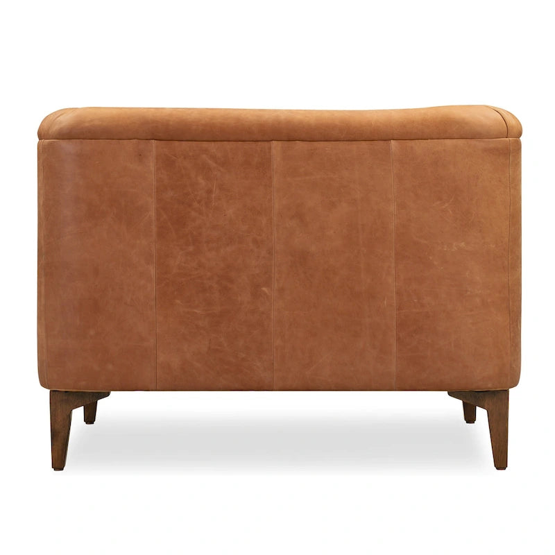 Fauteuil de salon capitonné en cuir italien avec pieds en bois massif et coussin en plumes