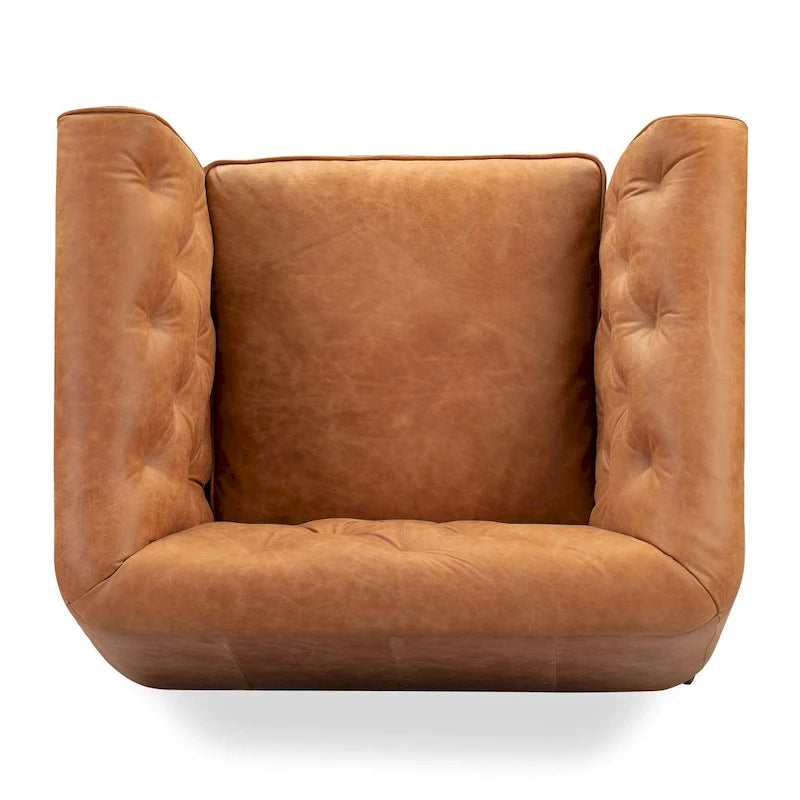 Fauteuil de salon capitonné en cuir italien avec pieds en bois massif et coussin en plumes
