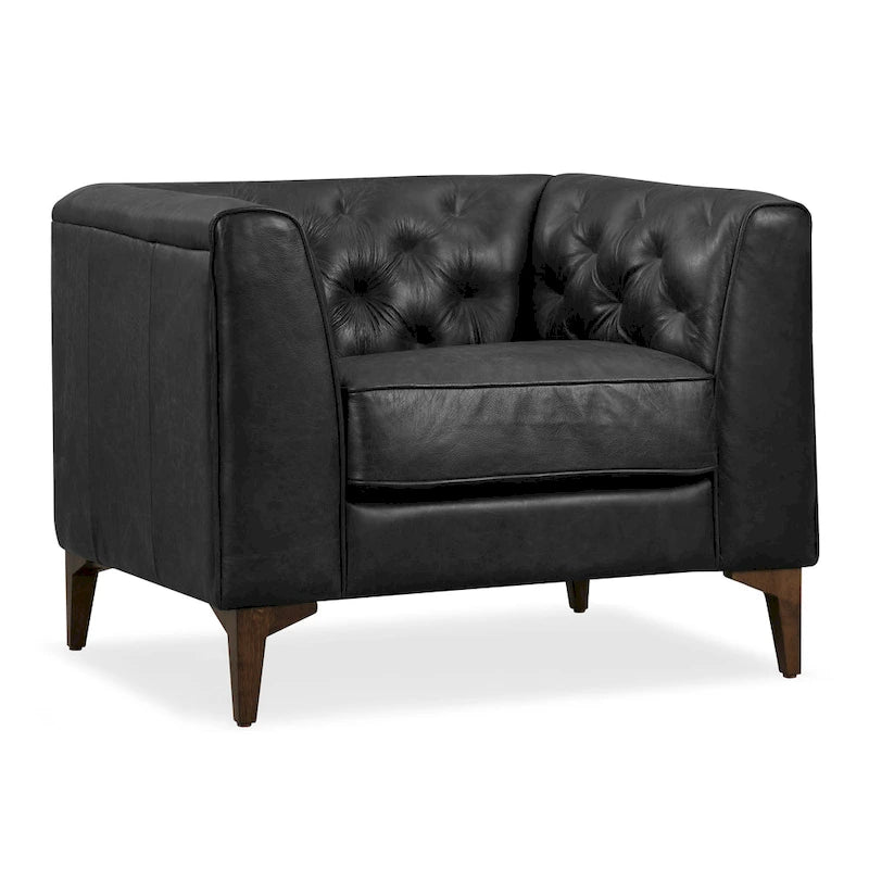 Fauteuil de salon capitonné en cuir italien avec pieds en bois massif et coussin en plumes