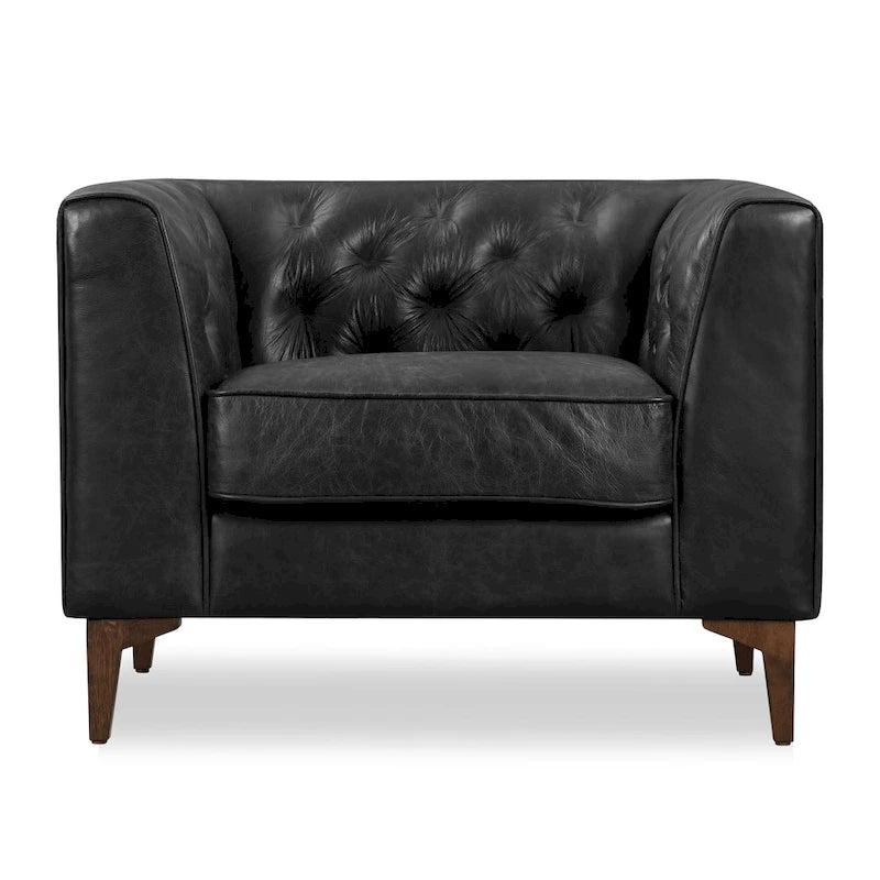 Fauteuil de salon capitonné en cuir italien avec pieds en bois massif et coussin en plumes