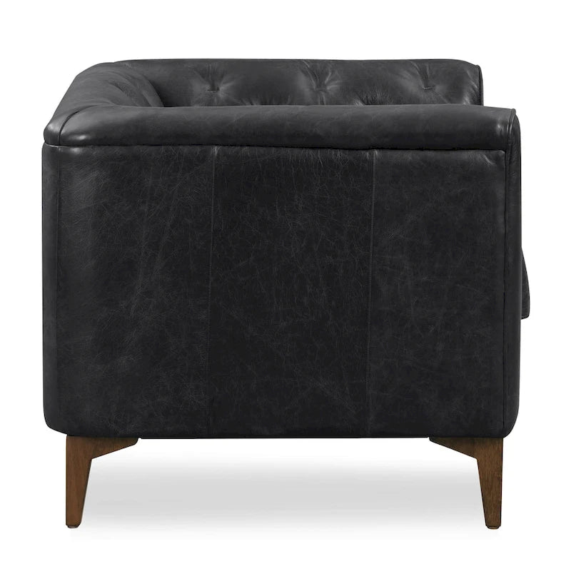 Fauteuil de salon capitonné en cuir italien avec pieds en bois massif et coussin en plumes