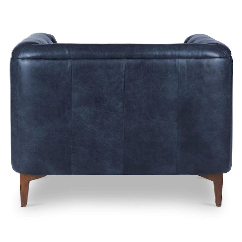 Fauteuil de salon capitonné en cuir italien avec pieds en bois massif et coussin en plumes